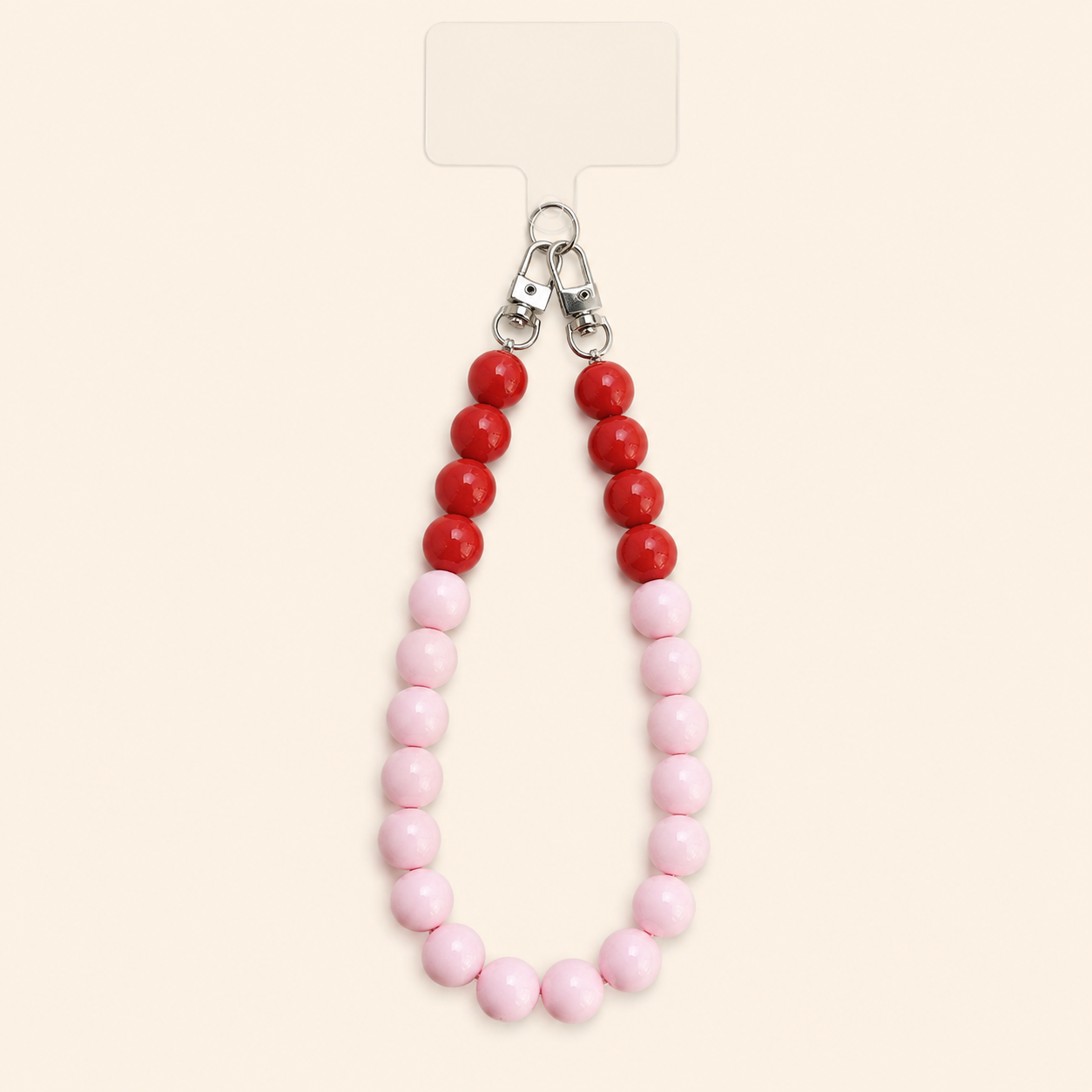 שרשרת CANDY LOOP לטלפון מחרוזי אקריל ורודים ואדומים על רקע שמנת