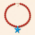 שרשרת CORAL STAR מאבני קורל עם תליון כוכב מפליז וסוגר בציפוי זהב